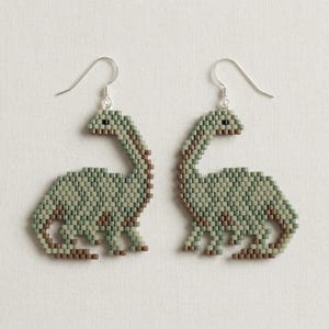 May include: A set of three ceramic mugs with a speckled, matte finish. The mugs are in shades of cream, light gray, and dark gray. Each mug has a simple, minimalist design, perfect for coffee or tea.