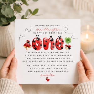May include: A square greeting card featuring the text RSD 2135, TO OUR PRECIOUS Granddaughter HAPPY 1ST BIRTHDAY, and the word one in red ladybug-patterned letters. It includes illustrations of ladybugs, a mushroom, and a clover, with a poem.