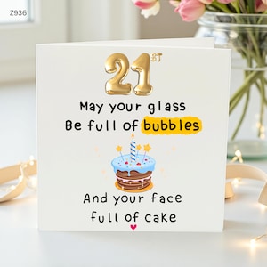 May include: A white birthday card with gold foil number "21" and the text "May your glass be full of bubbles and your face full of cake." A cake illustration with a candle is also featured.