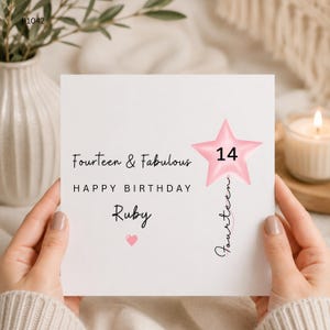 May include: A square white birthday greeting card featuring the text Fourteen & Fabulous, HAPPY BIRTHDAY, and the name Ruby in black script. A pink star-shaped balloon graphic displays the number 14, with the word fourteen written vertically.
