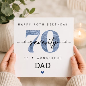 May include: A square white greeting card with the text HAPPY 70TH BIRTHDAY at the top. The number 70 is printed in a large blue textured font with the word seventy in black script across it. Below is TO A WONDERFUL DAD and a small blue heart.
