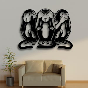 May include: A black metal wall art piece depicting the three wise monkeys: see no evil, hear no evil, speak no evil. The monkeys are in a sitting position with their hands covering their eyes, ears, and mouth. The artwork is mounted on a white wall.