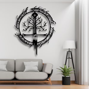 May include: Black metal wall art depicting a sword and tree design, surrounded by text. The artwork is mounted on a white wall above a grey sofa. A floor lamp and potted plant are also visible.