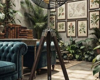 May include: A floor fan with a black wire cage and four yellow blades mounted on a dark brown wooden tripod stand. The fan features a central circular emblem and a black power cord hanging from the base, which is secured by a metal chain.