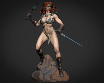 May include: A detailed figurine of a warrior woman with red hair, wearing a scale-mail bikini and boots. She holds a sword and a weapon with a spiked head, standing on a rock base. The figure has a determined expression.