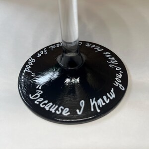 May include: Black wine glass with a white inscription that reads "Because I knew you'd been good for red so good."