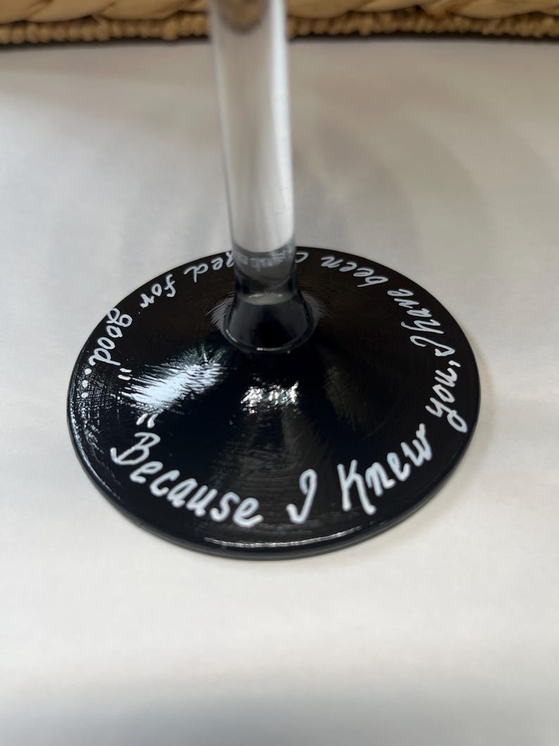 May include: Black wine glass with a white inscription that reads "Because I knew you'd been good for red so good."