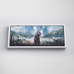 May include: A rectangular canvas wall art print featuring a landscape illustration of a figure standing in a field, carrying a sword on their back, facing snow-capped mountains and a forest under a bright sky, framed in a simple white border.