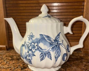 vintage teapot from the "Fruit" pattern featuring a blue fruit design on a white ribbed body