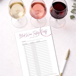 May include: Three wine glasses filled with white, rosé, and red wine, next to a "Blind Wine Tasting Party" voting card and a gold-accented pen. The card has spaces for scores and notes, perfect for a wine tasting event.
