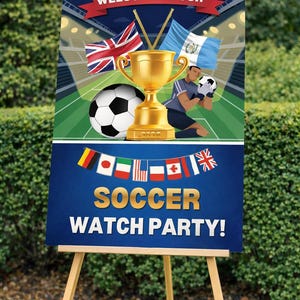 May include: A wooden easel displays a sign with a soccer theme. The sign features a gold trophy, soccer ball, and flags. Text reads "WELCOME TO OUR" and "SOCCER WATCH PARTY!" in gold lettering against a blue background.