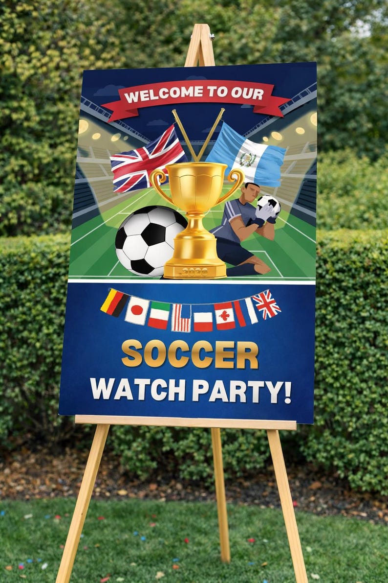 May include: A wooden easel displays a sign with a soccer theme. The sign features a gold trophy, soccer ball, and flags. Text reads "WELCOME TO OUR" and "SOCCER WATCH PARTY!" in gold lettering against a blue background.