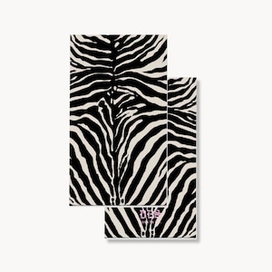 May include: Two rectangular cards featuring a high-contrast black and white zebra stripe pattern. The bottom card displays the text "DBS" in a stylized gothic font centered near the lower edge, with smaller text underneath the logo.
