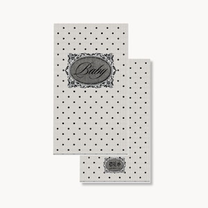 May include: Two rectangular paper napkins featuring a light cream background with a repeating pattern of small black polka dots. The larger napkin displays an oval frame with ornate black filigree edges containing the cursive text Baby.