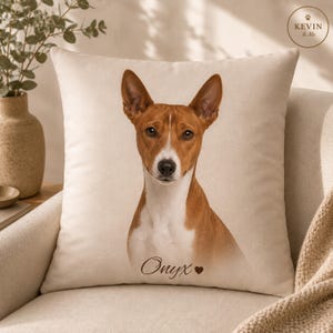 May include: Cream-colored square throw pillow featuring a Basenji dog portrait. The dog has a brown and white coat, with the name "Onyx" printed below. The pillow has a neutral background and a "KEVIN & Me" logo.