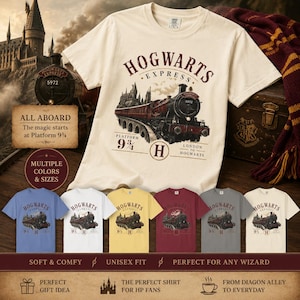 May include: A cream-coloured short-sleeve t-shirt featuring a graphic of the Hogwarts Express steam train. The design includes the text HOGWARTS EXPRESS, Platform 9 3/4, and London to Hogwarts. The shirt is displayed with smaller colour variations.