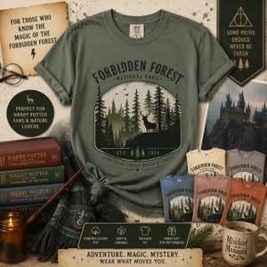 May include: A sage green short-sleeve t-shirt featuring a circular graphic of a forest, a stag, and a castle with the text Forbidden Forest National Park Est. 1326. The shirt includes a crew neck and a relaxed fit, displayed with other items.