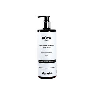 Könnte beinhalten: Eine 500 ml Flasche Koya Paris Conditioner mit schwarzem Pumpspender. Das weiße Etikett trägt schwarzen Text mit der Aufschrift Koya Paris, Conditionneur Densite Renforcee, Signature Densite Koya, 500 ml und Purete in französischer und englischer Sprache.