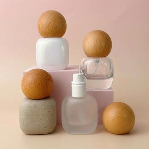 May include: A white ceramic mug with a black handle and the text "But First, Coffee" in a black, handwritten-style font. The mug is on a white surface.