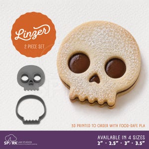May include: A 2-piece skull-shaped Linzer cookie cutter set made of food-safe PLA, shown with a finished skull cookie filled with dark jam and dusted with powdered sugar. The set is available in 2, 2.5, 3, and 3.5 inch sizes.
