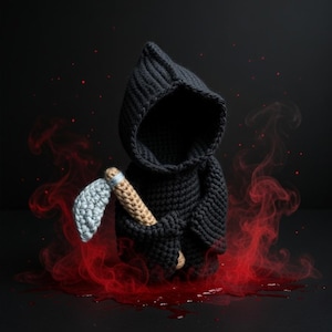 May include: A crocheted Grim Reaper figure in black with a hood, holding a scythe. The scythe has a light blue blade and a tan handle. Red smoke-like effects surround the figure against a black background.