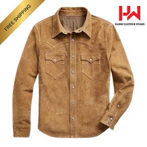 May include: A tan suede button-down shirt with two chest pockets and a classic collar. The shirt has long sleeves with buttoned cuffs. The upper left corner of the image has a gold banner that says "FREE SHIPPING". The logo "HASSH LEATHER WEARS" is in the upper right corner.