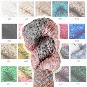 May include: A collection of yarn samples in various colors, including white, beige, light blue, gray, black, pink, red, blue, green, and yellow. The yarn is arranged in a grid pattern with numbers below each sample.