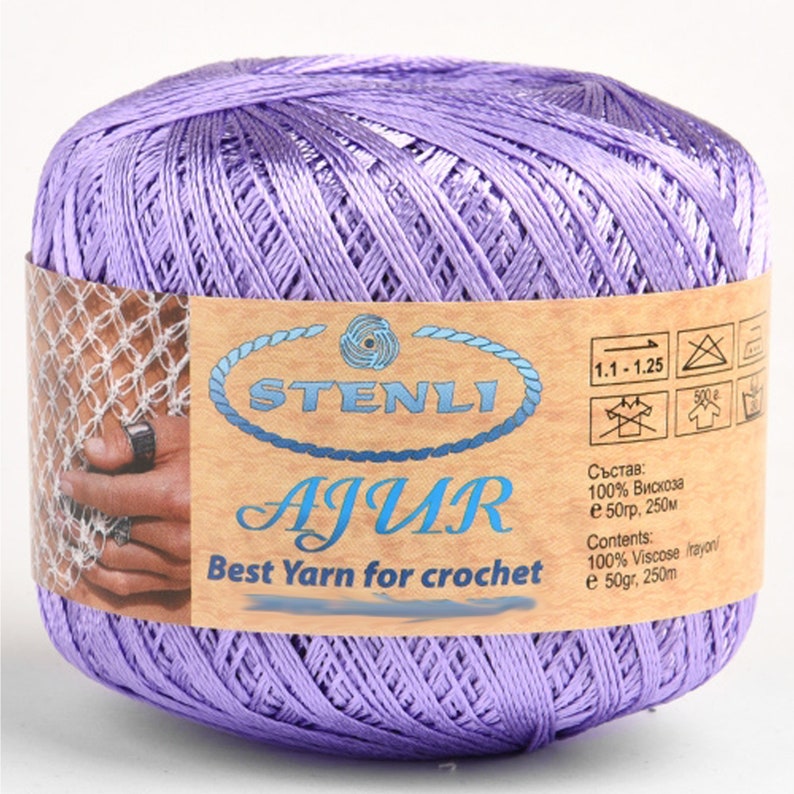 May include: A skein of lavender-colored yarn labeled "STENLI AJUR Best Yarn for crochet" with care instructions and composition information in both English and Russian. The yarn is 100% viscose and comes in a 50 gram, 250 meter skein.