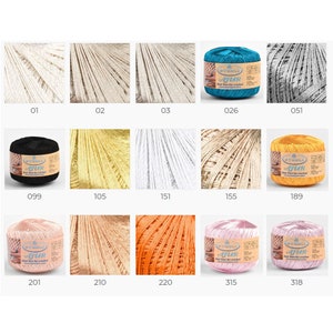 May include: A collection of yarn balls in various colors, including white, black, yellow, orange, pink, and blue. The yarn balls are arranged in a grid pattern and labeled with numbers.