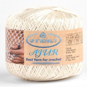 May include: A ball of off-white yarn labeled "STENLI AJUR Best Yarn for crochet" with a label that says "100% Viscose e 50gr, 250m" and "Contents: 100% Viscose /rayon e 50gr, 250m".