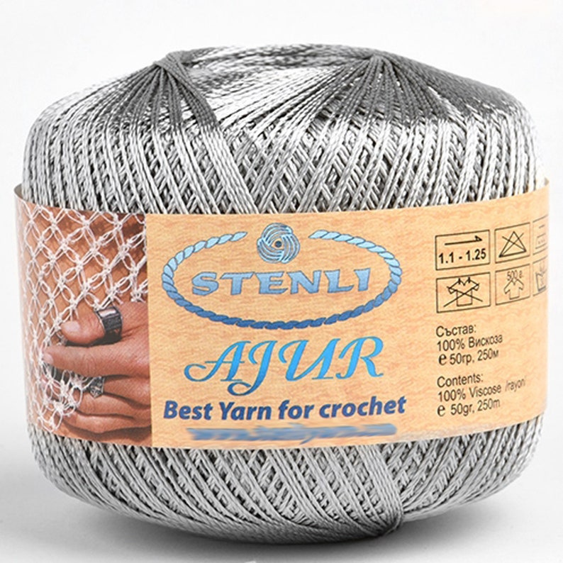 May include: A silver ball of yarn labeled "STENLI AJUR Best Yarn for crochet" with a tag that reads "1.1-1.25 Състав: 100% Вискоза е 50гр, 250м Contents: 100% Viscose rayon e 50gr, 250m".