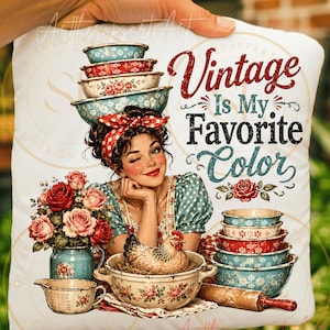 May include: White pillow with a vintage-themed design. The pillow features a woman winking, stacked bowls, roses, and a chicken in a bowl. Text on the pillow reads "Vintage Is My Favorite Color."