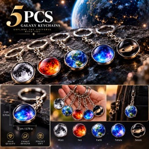 Op de afbeelding: Een set van 5 sterrenstelsel-sleutelhangers met ronde glazen cabochons met ruimte-thema's zoals de maan, zon, aarde, nevel en Saturnus. Elke sleutelhanger heeft een diameter van 2 cm en is voorzien van een metalen ring en ketting.