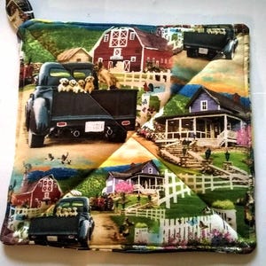 May include: Square quilted pot holder with a rural scene featuring a black truck filled with puppies, red barns, and white fences. The fabric has a colorful patchwork design with a loop for hanging.