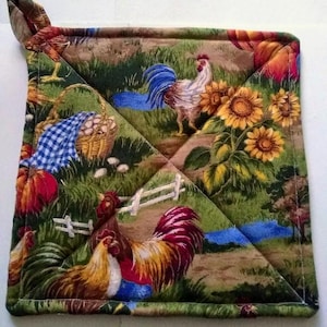 May include: A quilted pot holder with a farmhouse theme. The fabric features a brown background with a green, yellow, and blue pattern of roosters, sunflowers, pumpkins, and eggs.