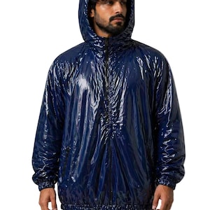 May include: A shiny, navy blue hooded jacket with a full-length zipper. The jacket has a glossy, reflective finish and elastic cuffs. The hood is up, and the jacket appears to be made of a waterproof material. The jacket is worn over a dark shirt.