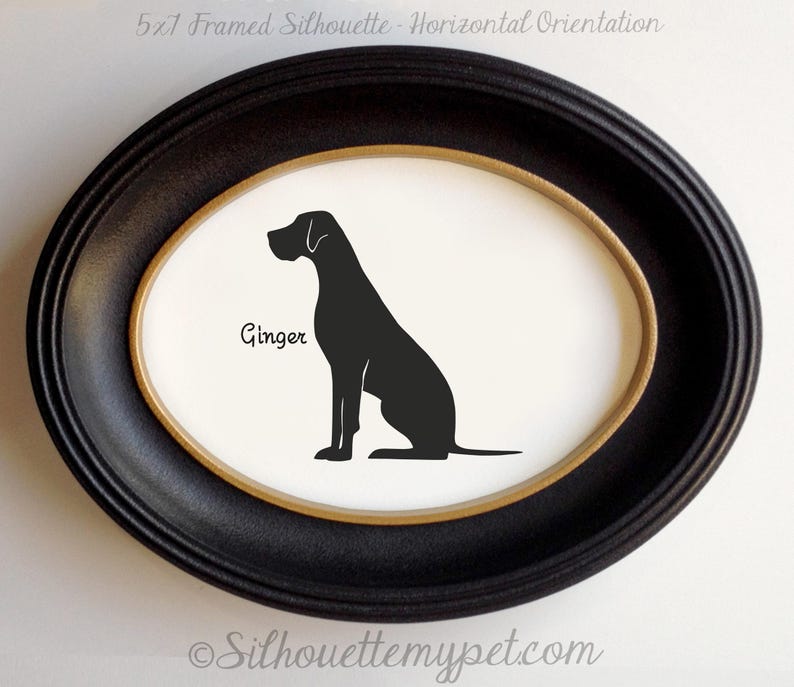 May include: A framed silhouette of a dog named "Ginger" in a black oval frame. The dog is depicted in black against a white background. The frame has a gold inner border and the text "5x7 Framed Silhouette - Horizontal Orientation" is at the top.