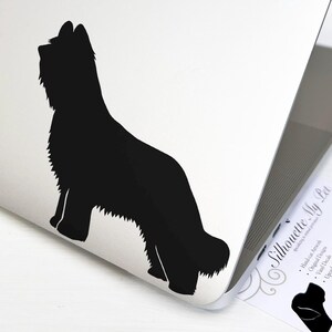 May include: Black silhouette of a Bearded Collie dog on a white laptop. The silhouette is a vinyl sticker with the text "Silhouette My Pet" in the background.