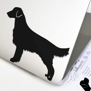 May include: Black silhouette of a Flat-Coated Retriever dog on a white laptop. The laptop is open and a business card for "Silhouette My Pet" is visible.