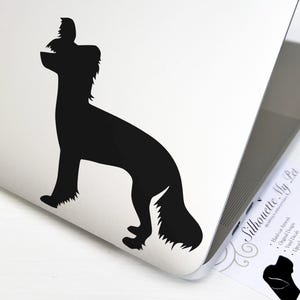 May include: Black silhouette of a Chinese Crested dog standing on its hind legs with its head tilted back and its tongue sticking out. The silhouette is on a white background.