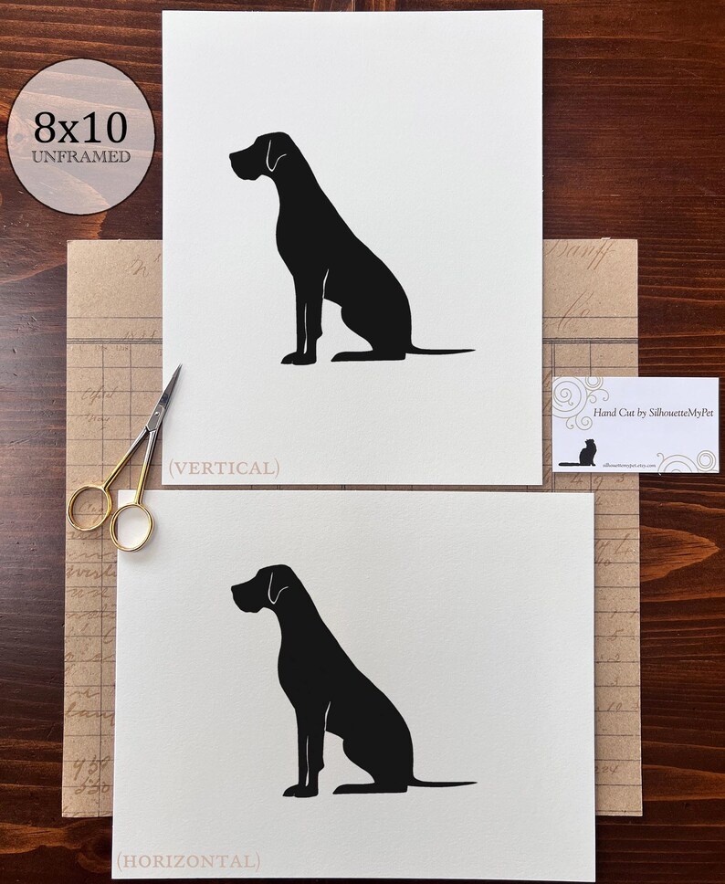 May include: Two prints of a black dog silhouette, one vertical and one horizontal, on white paper. The prints are labeled "8x10 UNFRAMED". The text "(VERTICAL)" and "(HORIZONTAL)" are below the prints. A business card reads "Hand Cut by SilhouetteMyPet".
