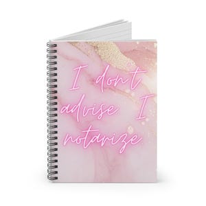 May include: Spiral-bound notebook with a pink marble design and gold accents. The cover features the neon pink text, "I don't advise I notarize." The notebook is open, revealing lined pages. The spiral binding is black.