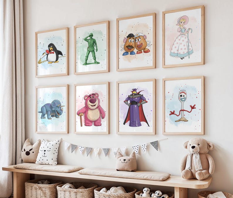 May include: Eight framed art prints featuring characters from the animated movie Toy Story. The prints include images of a penguin, a green soldier, Mr. and Mrs. Potato Head, Bo Peep, a blue dinosaur, Lotso, Zurg, and Forky. The prints are displayed on a white wall.