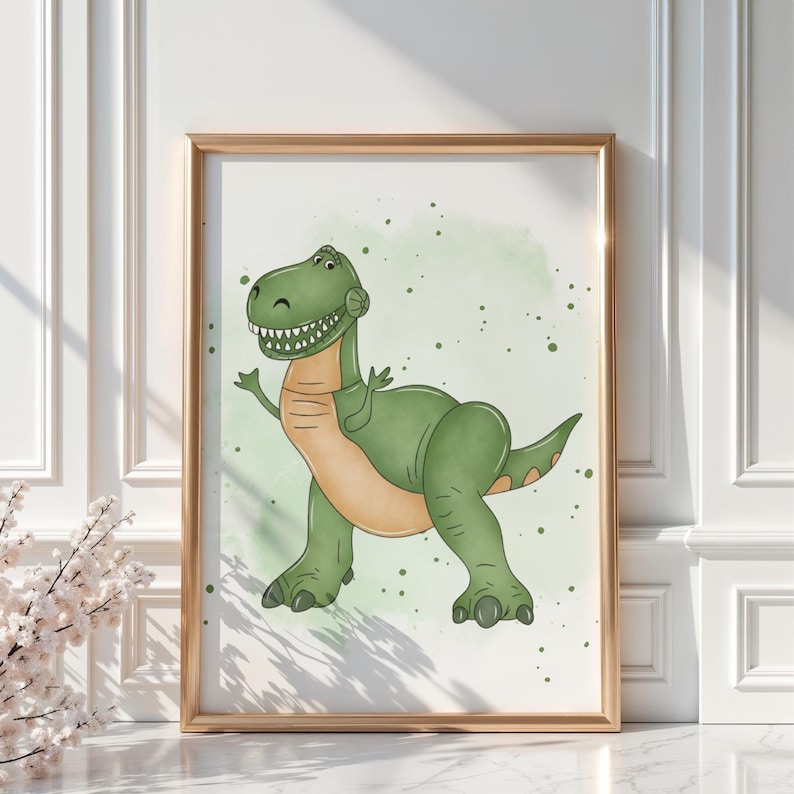 May include: A framed print featuring a friendly cartoon Tyrannosaurus Rex. The dinosaur is primarily green with a tan belly and arms, set against a light green watercolor background with splatters. The artwork is in a gold frame.