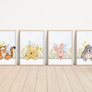 May include: Four framed art prints featuring Winnie the Pooh characters: Tigger, Winnie the Pooh, Piglet, and Eeyore. Each print has a white background with watercolor flowers and the character peeking over a white ledge.