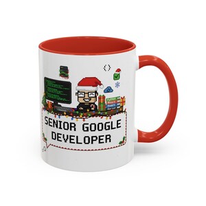 Pode incluir: Caneca de cerâmica branca com interior e alça vermelhos. A caneca apresenta um design pixelizado de um desenvolvedor com um chapéu de Papai Noel, uma tela de computador e o texto "SENIOR GOOGLE DEVELOPER". Luzes festivas e ícones de feriados decoram o design.