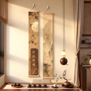 May include: Two vertical Asian-style wall scrolls with bamboo and mountain landscape paintings. One scroll features a full moon and bamboo. The other depicts a mountain range. A wooden sign with Chinese characters hangs below the bamboo scroll. The room has a tea set on a table.