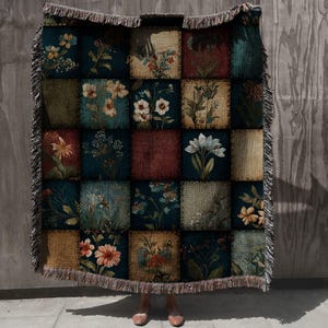 May include: A patchwork throw blanket featuring floral designs in squares of various colors, including teal, burgundy, and beige. The blanket has a fringed edge and a vintage aesthetic, perfect for adding a touch of rustic charm to any space.