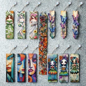 May include: A selection of decorative bookmarks with diverse designs. Some depict illustrations of women with floral details, butterflies, and abstract faces. Others feature colourful floral and textured patterns. Each bookmark has a crystal charm attached.