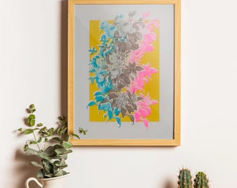 May include: A framed art print with a floral design. The print displays a bouquet of flowers in grey, blue, and pink hues set against a yellow backdrop. The artwork is enclosed within a light brown wooden frame.